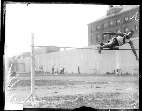 ECC | [African American track and field athlete Shaw leaping over